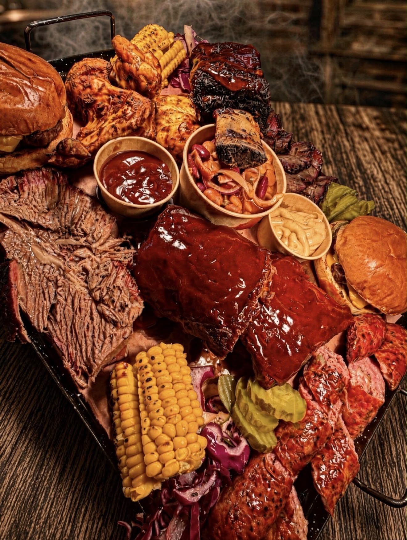 Henry’s Smokehouse sharing platter with smoked ribs, brisket, corn and sides