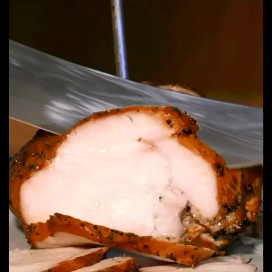 Sliced smoked turkey crown being carved at Henry’s Smokehouse